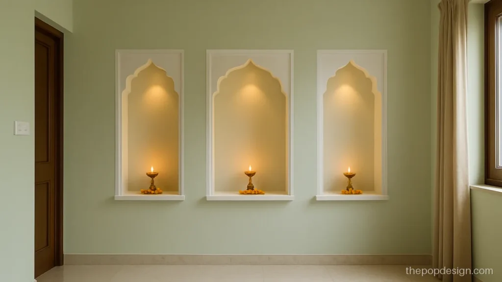 Three scalloped arch niches in a pooja room POP wall design